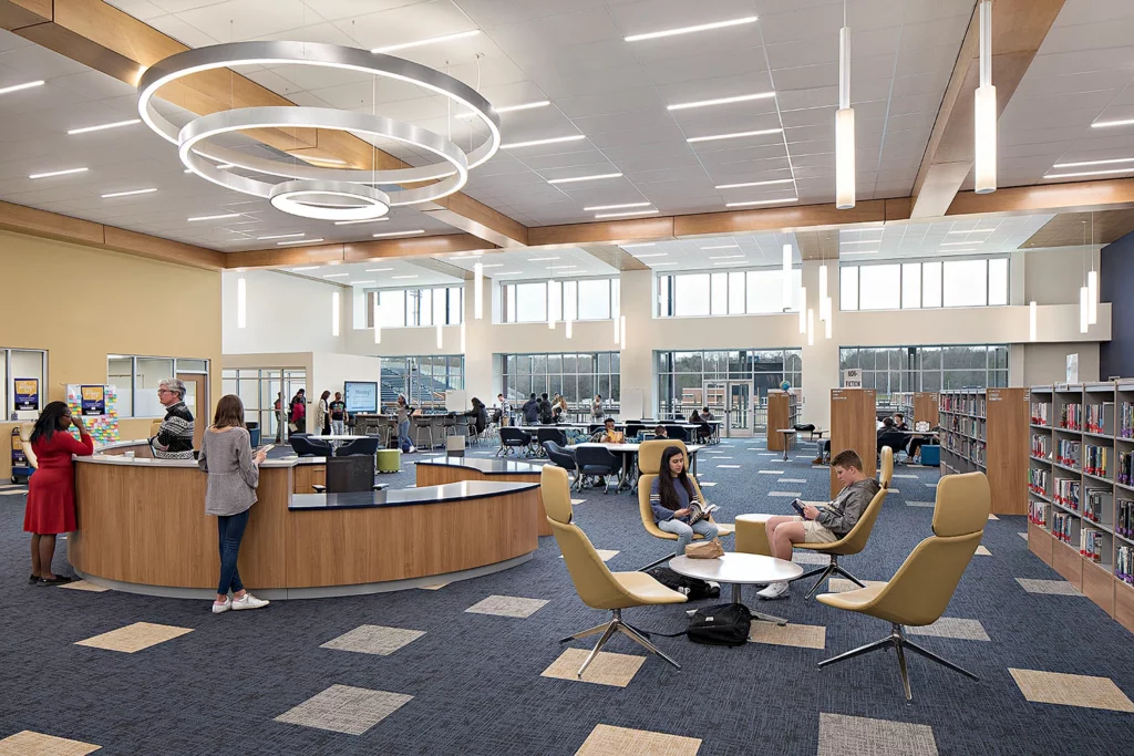 Library Learning Centre at Spartanburg High. The space is brightly lit and filled with circular tables.