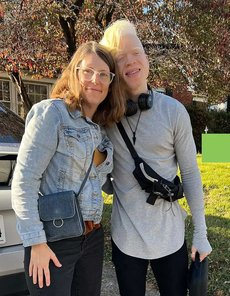 Lynn Ouellette and RobenX standing with their arms around each other, smiling.