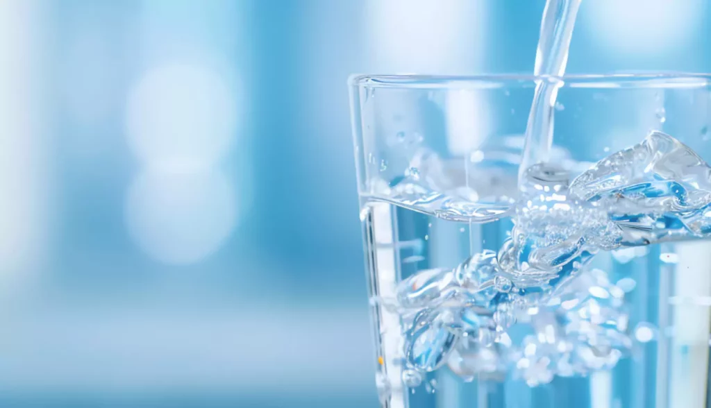 Image of water being poured into a glass.